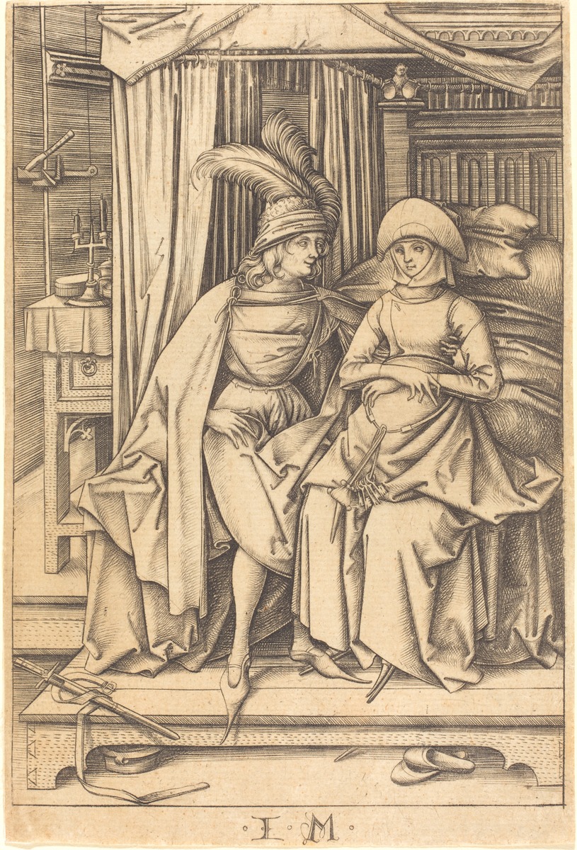 couple seated on a bed